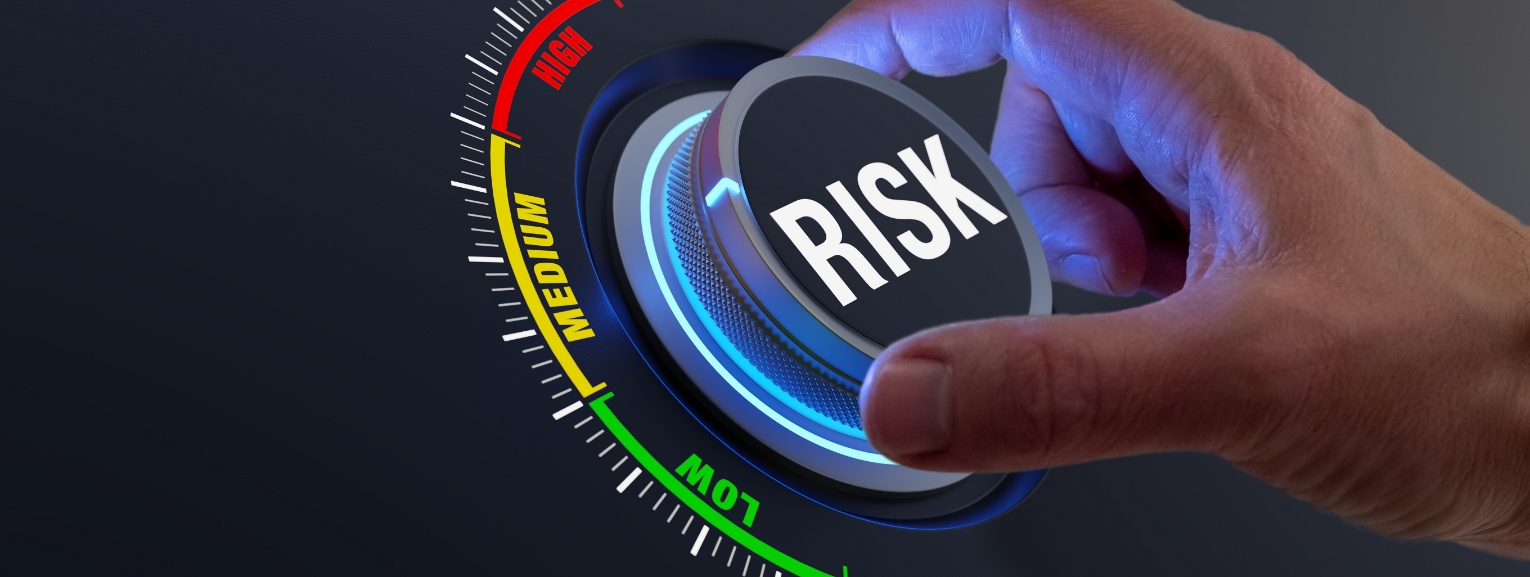 Hand adjusting a risk control dial with levels ranging from low to high.